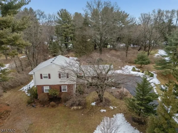 a view of a big house with a yard and tree s