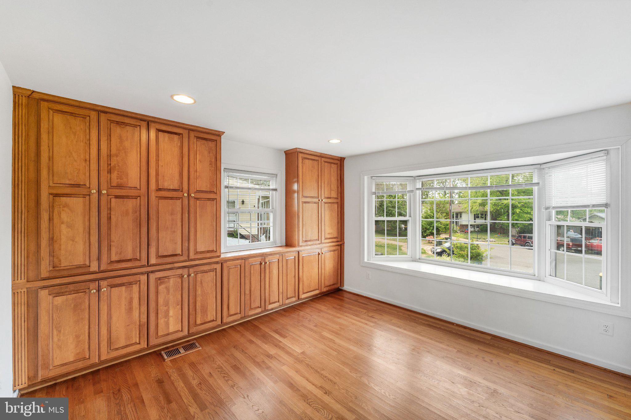 6423 Cabell Court Springfield, VA 22150 - Photo 14 of 58 a view of an empty room with wooden floor and a window
