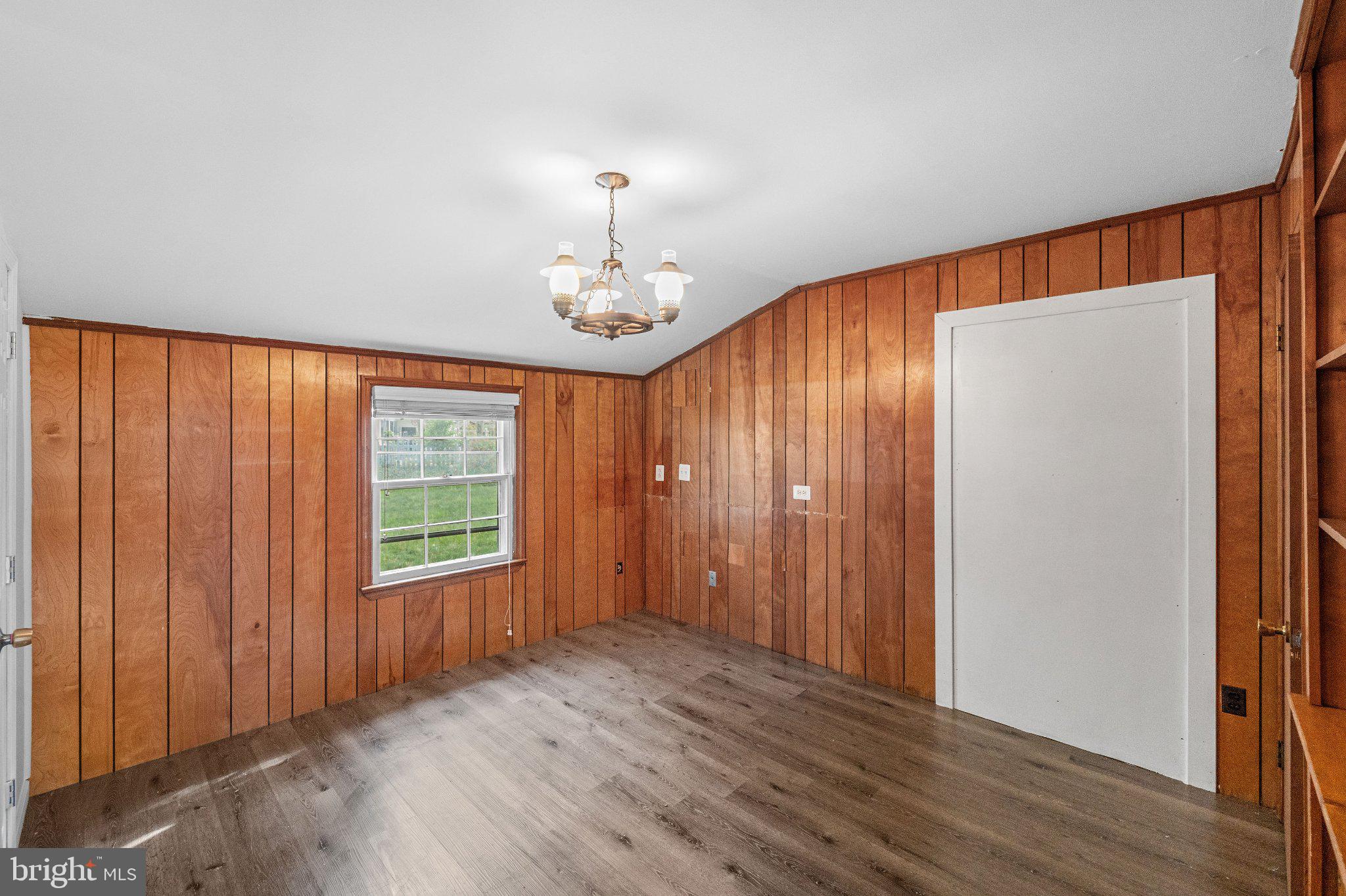 6423 Cabell Court Springfield, VA 22150 - Photo 17 of 58 an empty room with wooden floor chandelier fan and windows