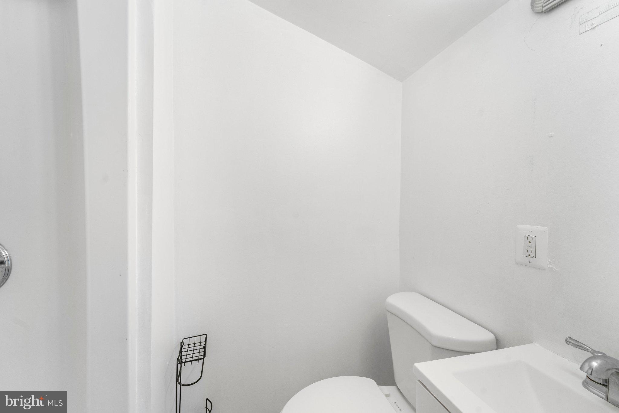 6423 Cabell Court Springfield, VA 22150 - Photo 19 of 58 a white toilet sitting next to a white sink and vanity