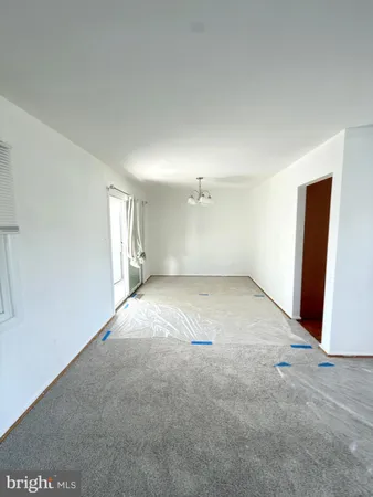 an empty room with a empty space and windows