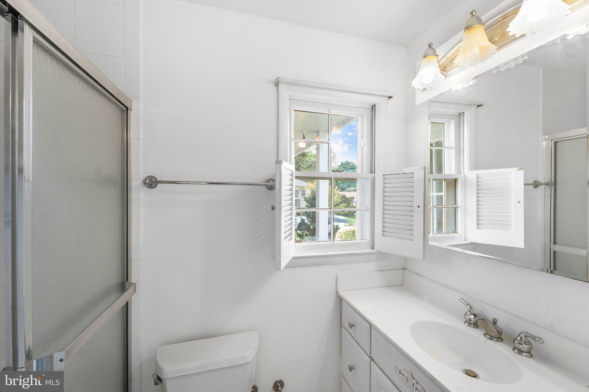 6423 Cabell Court Springfield, VA 22150 - Photo 24 of 58 a bathroom with a sink a toilet and a window