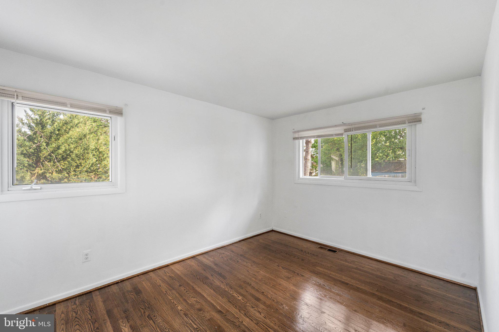 6423 Cabell Court Springfield, VA 22150 - Photo 25 of 58 an empty room with wooden floor and windows