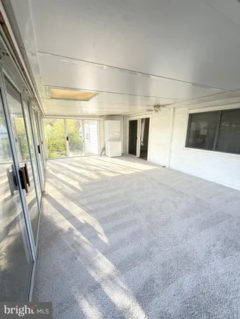 a view of a hallway to rooms