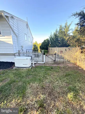 a view of house with backyard and garden