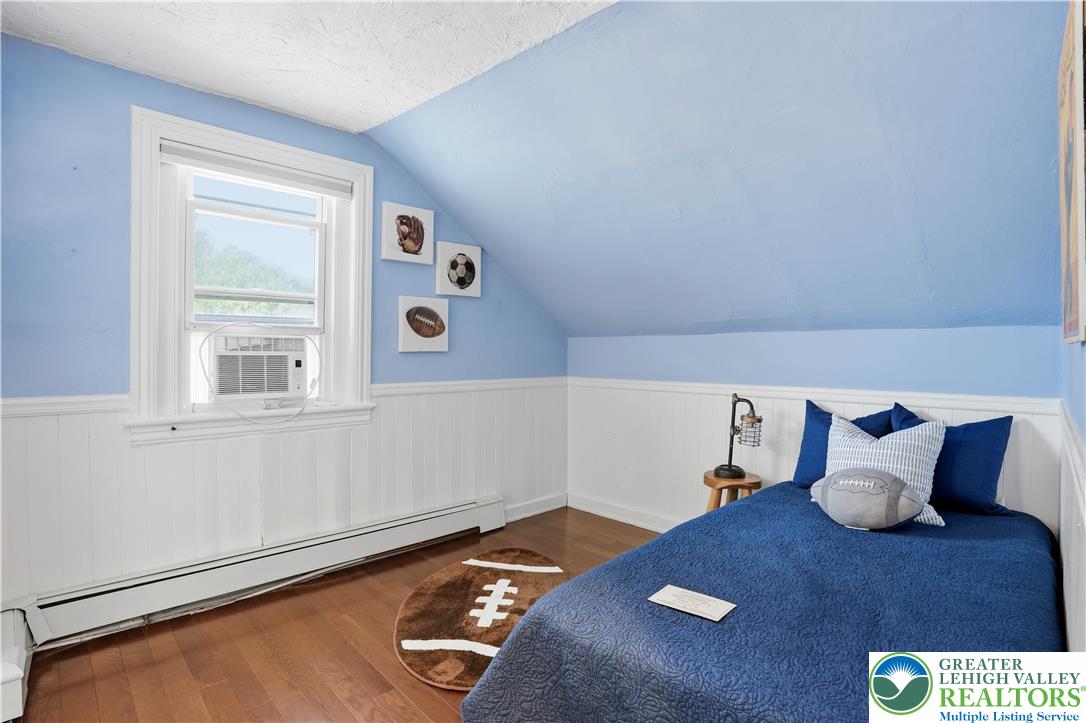 2014 Linden Street Bethlehem, PA 18017 - Photo 45 of 85 Hardwood flooring and paneled walls define this cozy bedroom with sloped ceilings.
