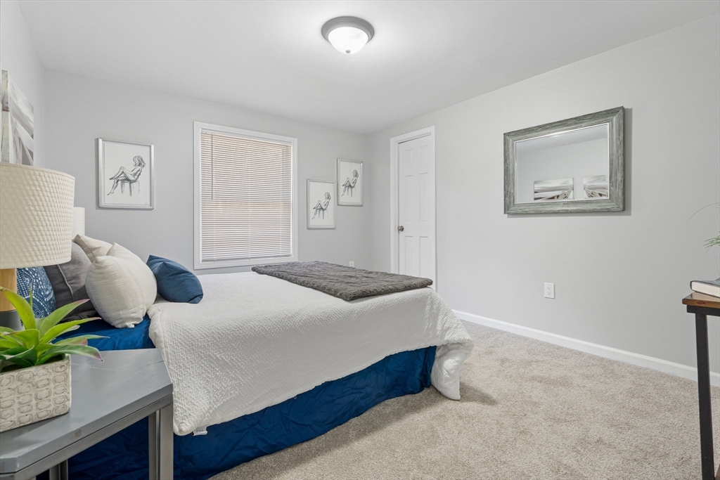 41 Casey Road Spencer, MA 01562 - Photo 17 of 39 a bedroom with a bed and wooden floor