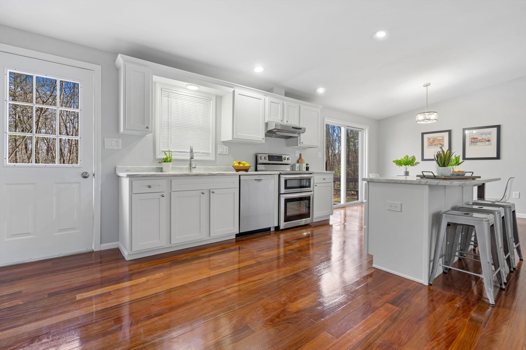 41 Casey Road Spencer, MA 01562 - Photo 5 of 39 a kitchen with stainless steel appliances granite countertop a stove a sink a refrigerator white cabinets and wooden floor