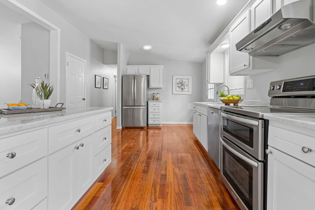 41 Casey Road Spencer, MA 01562 - Photo 9 of 39 a kitchen with stainless steel appliances a stove a refrigerator and a hard wood floor