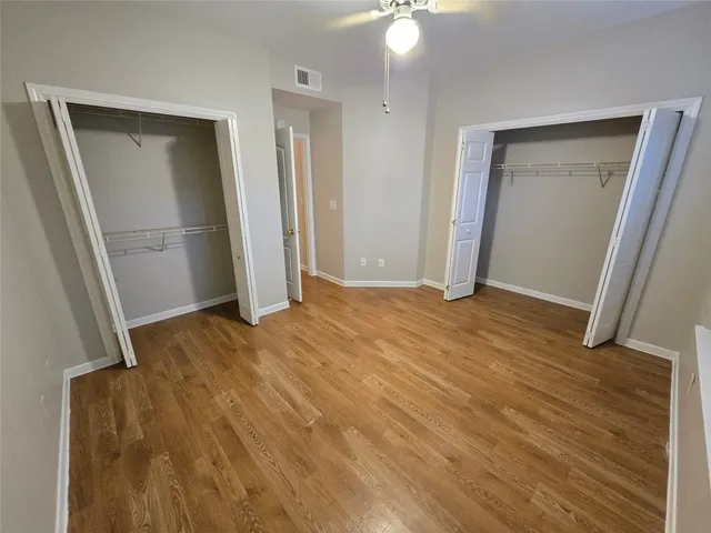 an empty room with wooden floor and closet