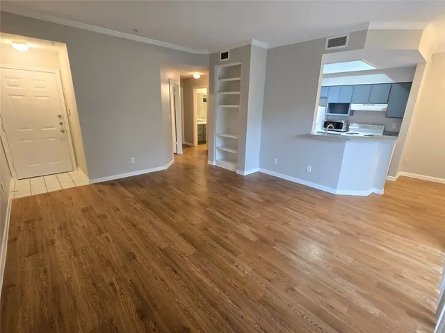 a view of a kitchen with a sink and a mirror