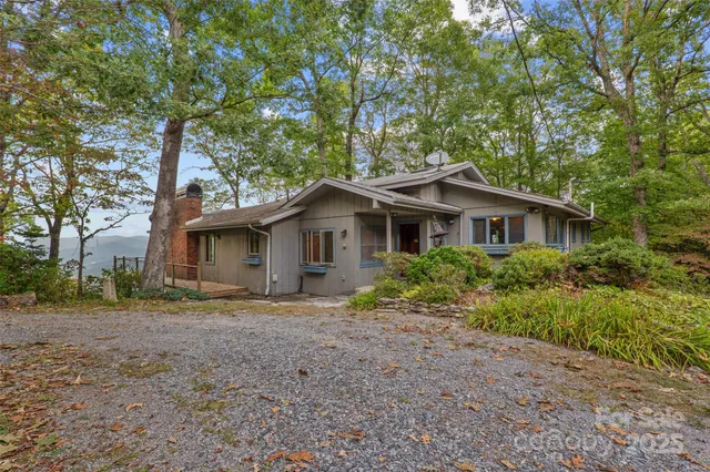 a view of a room with wooden floor and windows