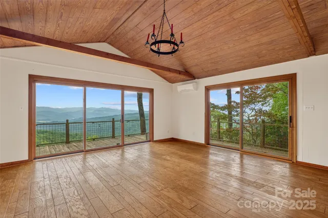 a view of a livingroom with wooden floors and fireplace
