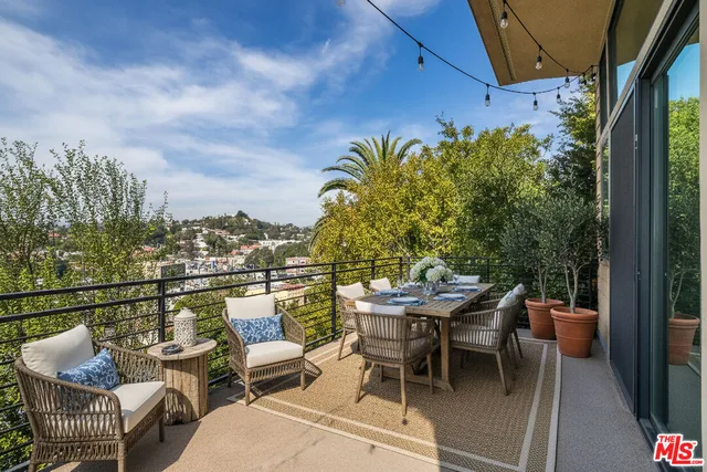 a view of a terrace with couches and potted plants