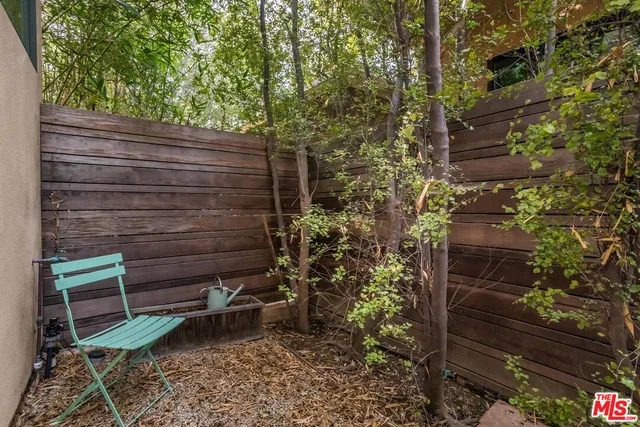 a backyard of a house with outdoor seating
