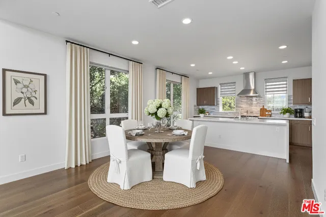 a living room with kitchen island furniture and a kitchen view