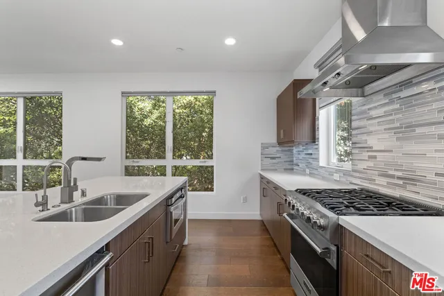 a kitchen with a sink and a stove top oven