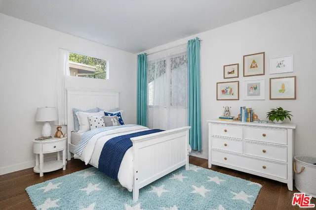 a bedroom with a bed and a dresser