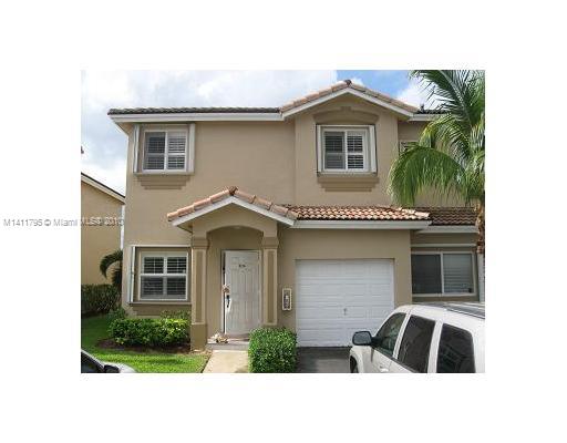 2314 Southeast 23rd Road, Unit 2314 Homestead, FL 33035 - Photo 1 of 13 a front view of a house with a garden