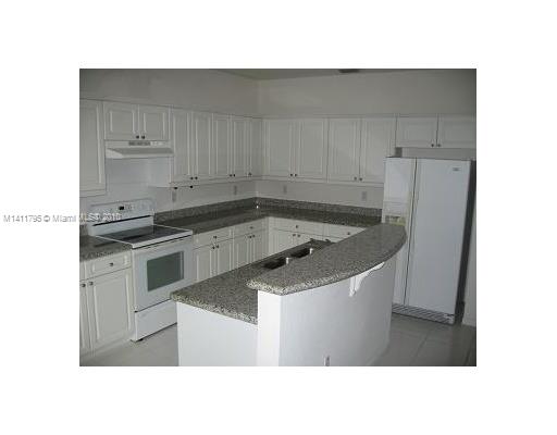 2314 Southeast 23rd Road, Unit 2314 Homestead, FL 33035 - Photo 6 of 13 a kitchen with a sink and cabinets