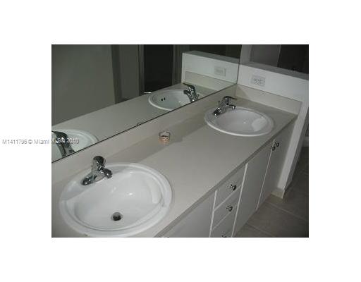 2314 Southeast 23rd Road, Unit 2314 Homestead, FL 33035 - Photo 10 of 13 a bathroom with a sink and mirror