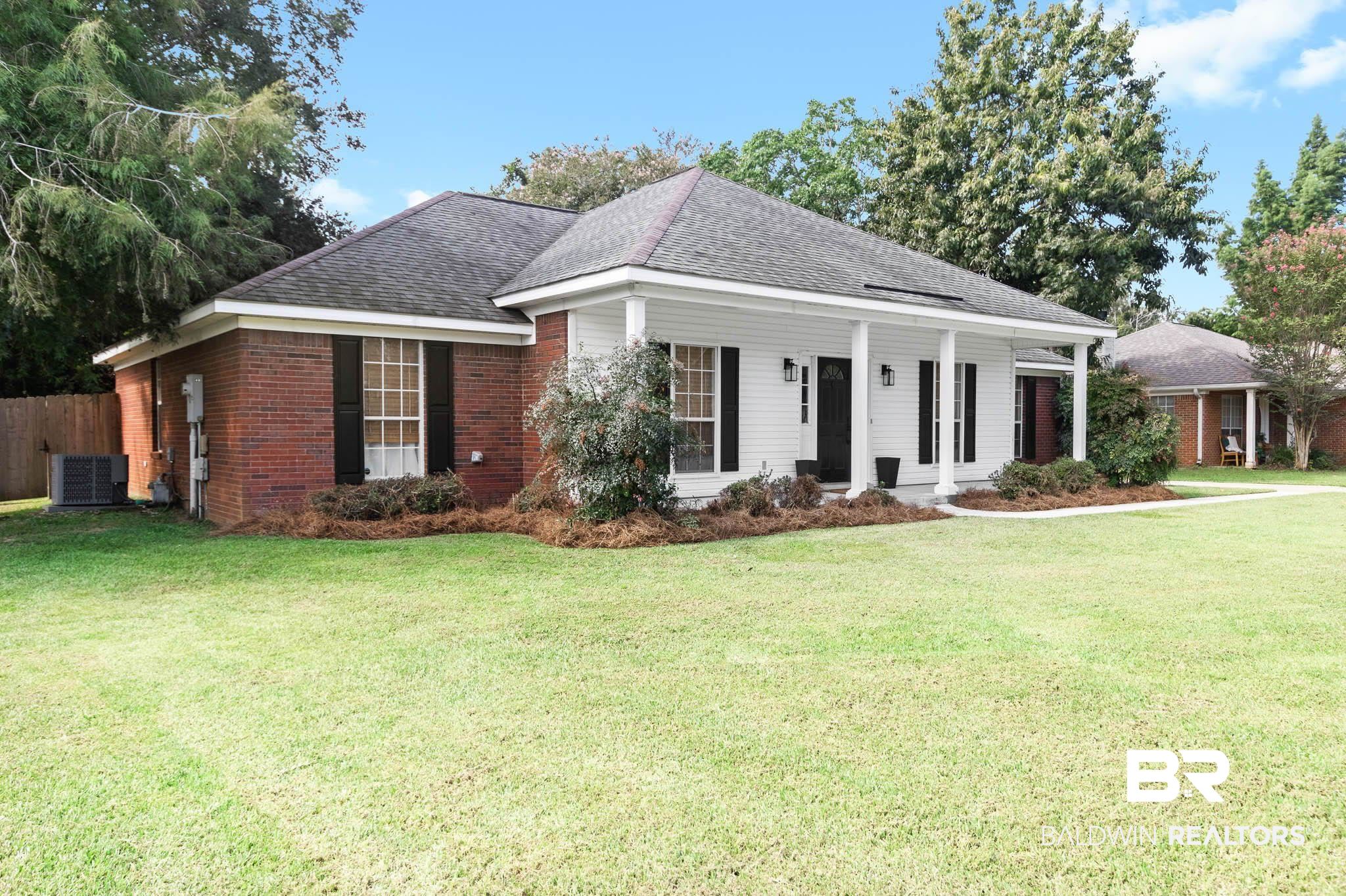 20685 Lowry Drive Fairhope, AL 36532 - Photo 2 of 48 View of front of property with a porch, a shingled roof, a front yard, and brick siding