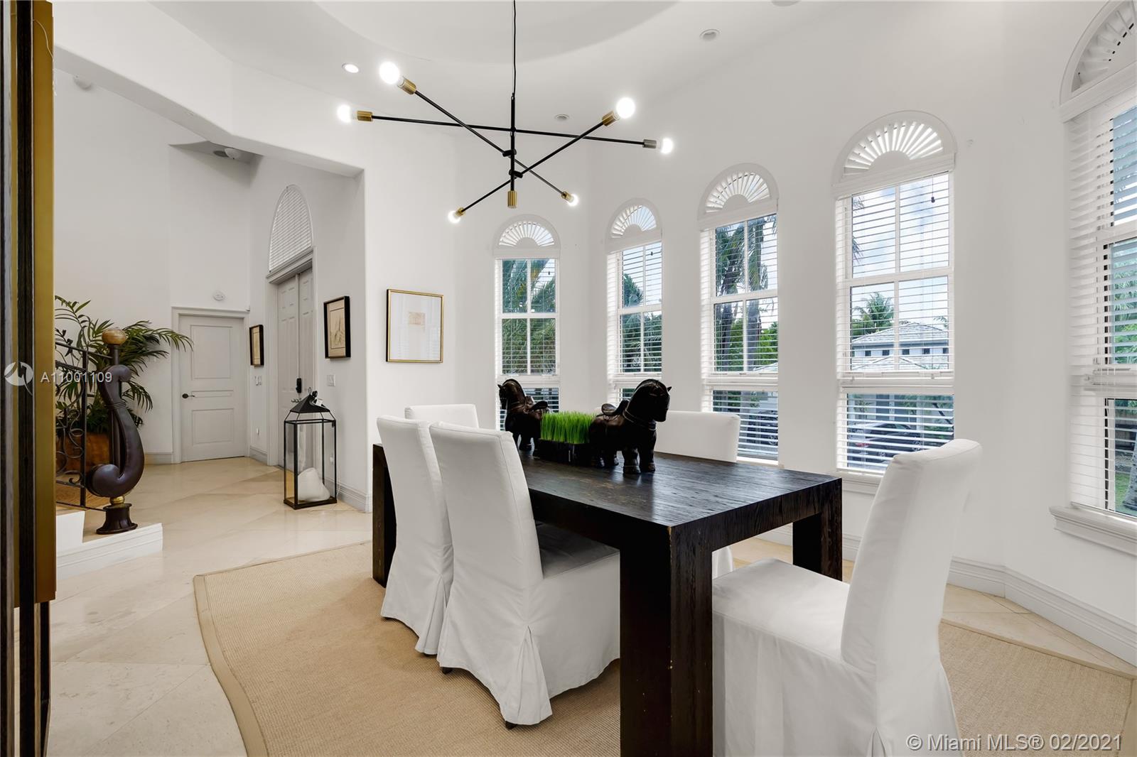 570 Hampton Lane Key Biscayne, FL 33149 - Photo 14 of 60 a view of a dining room with furniture and a chandelier