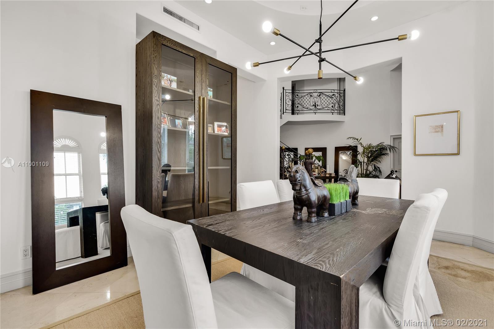 570 Hampton Lane Key Biscayne, FL 33149 - Photo 15 of 60 a view of a dining room with furniture and wooden floor