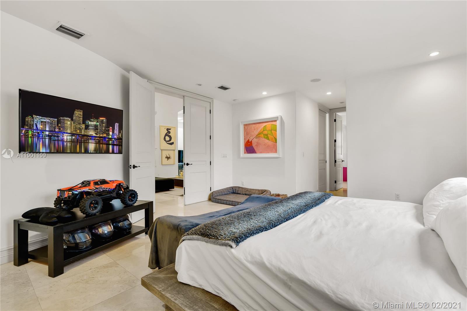 570 Hampton Lane Key Biscayne, FL 33149 - Photo 22 of 60 a spacious bedroom with a bed and a couch