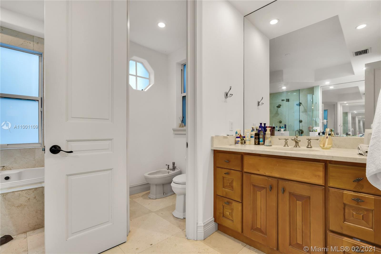 570 Hampton Lane Key Biscayne, FL 33149 - Photo 27 of 60 a bathroom with a toilet sink and mirror