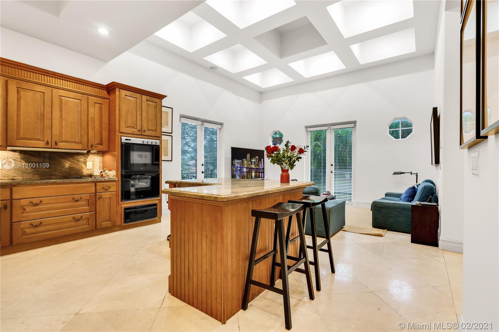 570 Hampton Lane Key Biscayne, FL 33149 - Photo 30 of 60 a kitchen with stainless steel appliances kitchen island granite countertop a refrigerator and microwave