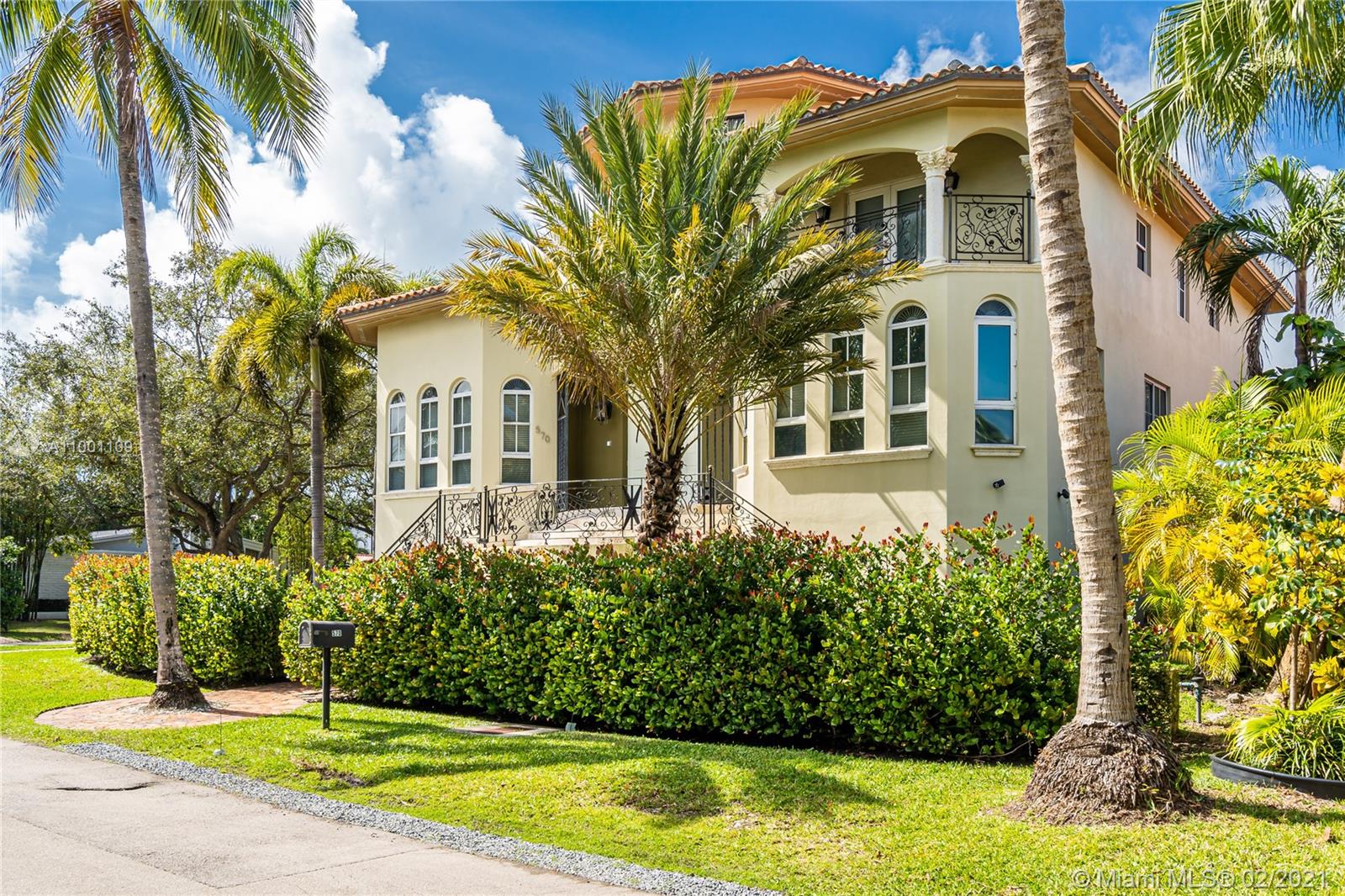 570 Hampton Lane Key Biscayne, FL 33149 - Photo 5 of 60 a front view of a house with a yard