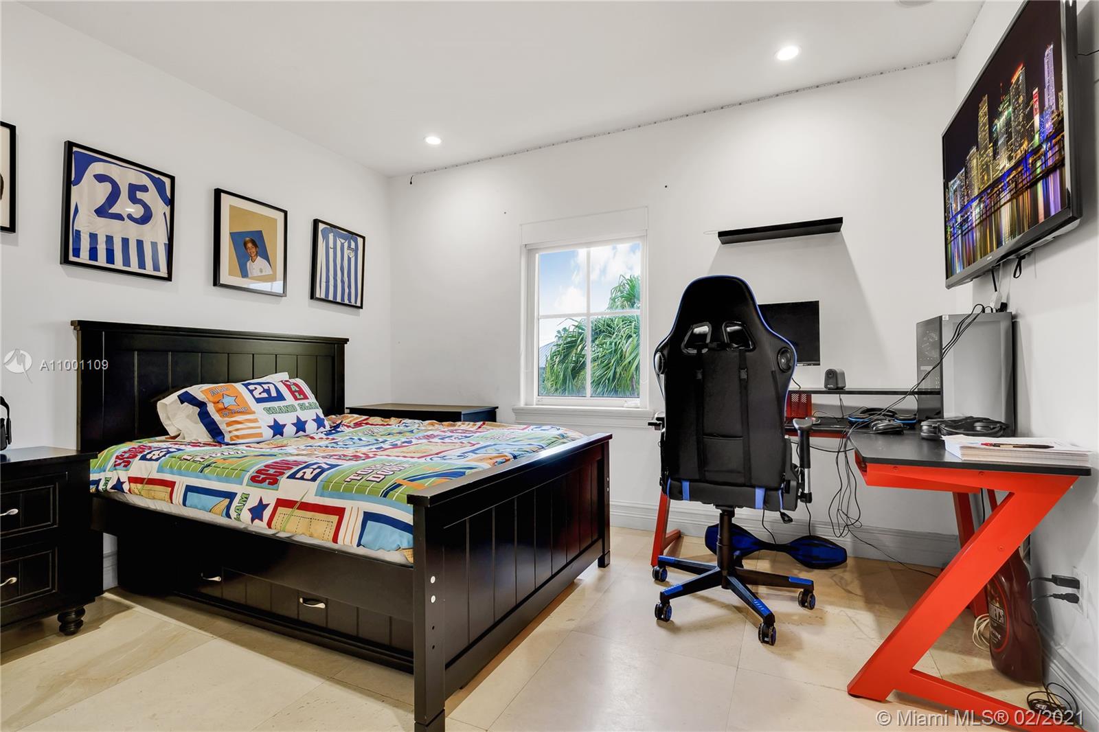 570 Hampton Lane Key Biscayne, FL 33149 - Photo 41 of 60 a bedroom with a bed and a bookshelf with the wooden floor