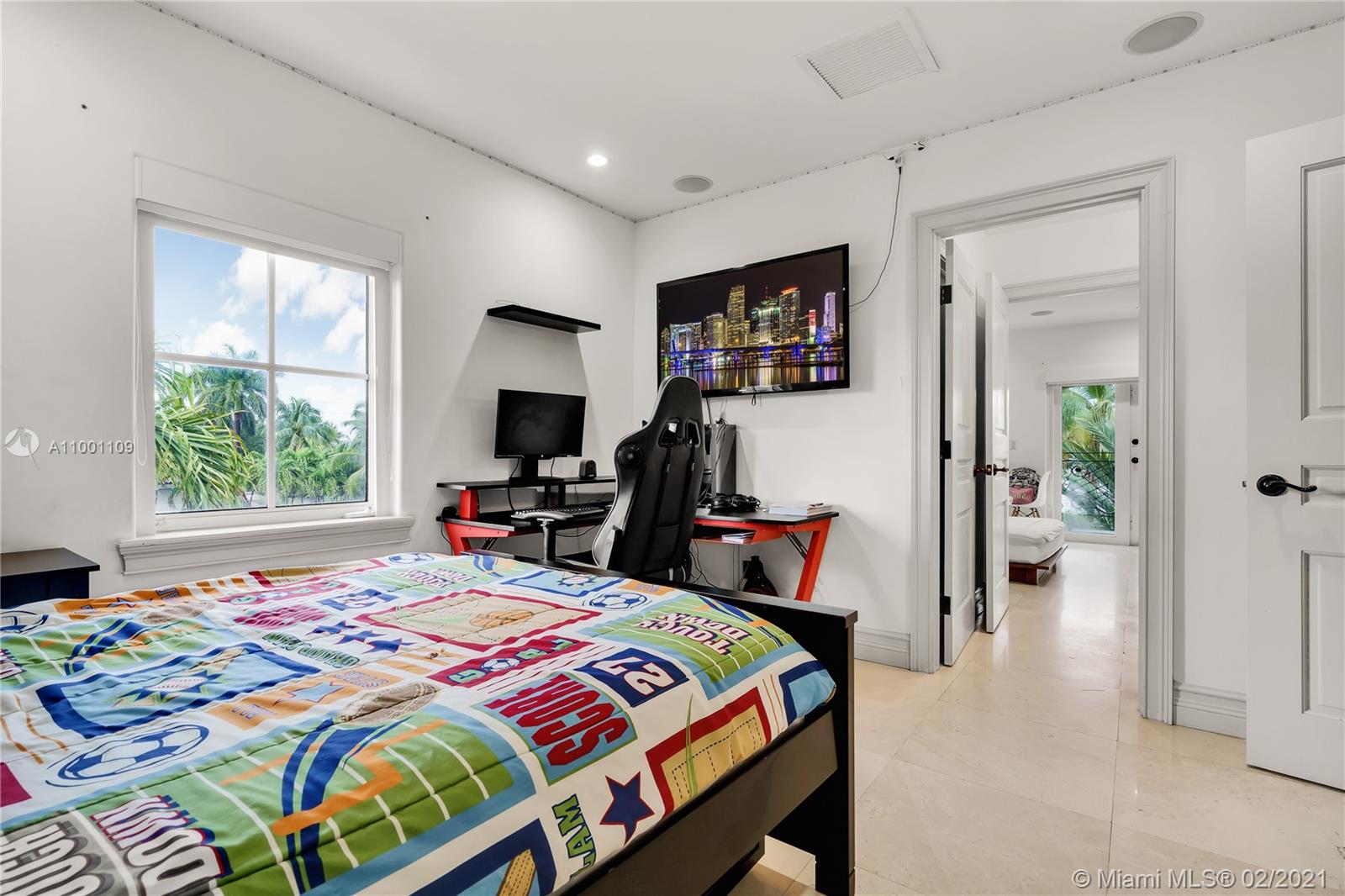 570 Hampton Lane Key Biscayne, FL 33149 - Photo 42 of 60 a bedroom that has a bed and a tv in it