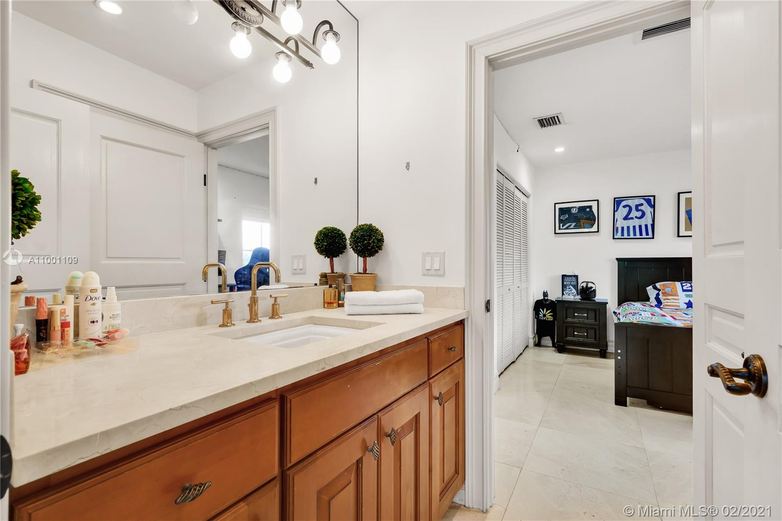 570 Hampton Lane Key Biscayne, FL 33149 - Photo 44 of 60 a kitchen with a sink dishwasher and a stove with wooden floor