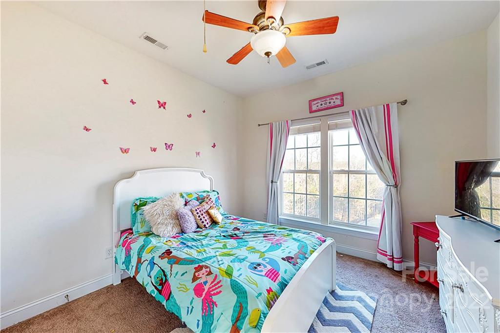 349 Fischer Road Fort Mill, SC 29715 - Photo 27 of 47 a bedroom with a bed and a tv