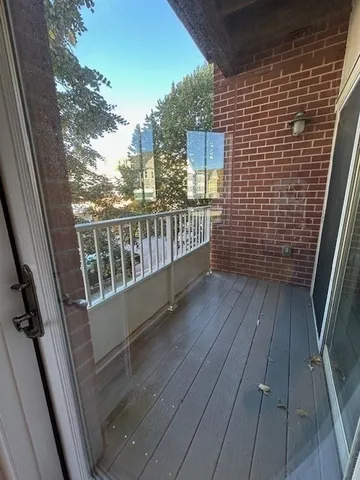 a view of balcony with wooden floor
