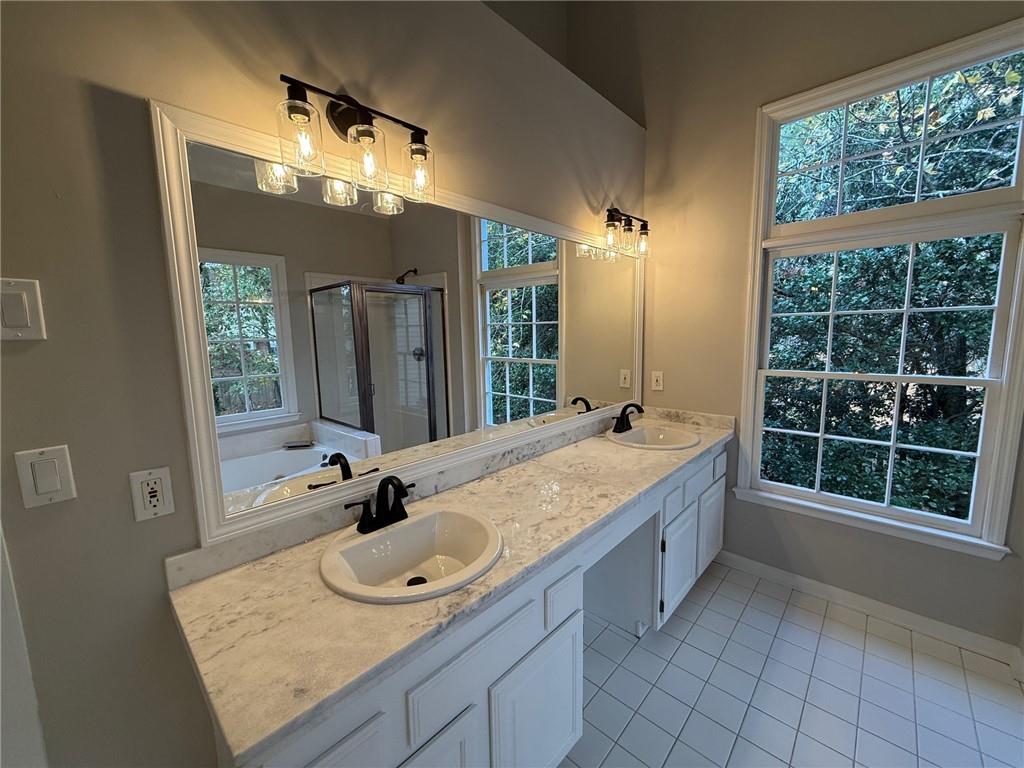 5325 Hillgate Crossing Alpharetta, GA 30005 - Photo 18 of 35 a bathroom with a granite countertop sink and a mirror