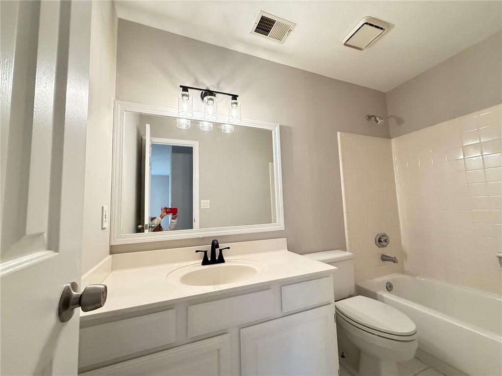 5325 Hillgate Crossing Alpharetta, GA 30005 - Photo 29 of 35 a bathroom with a toilet a sink and a mirror