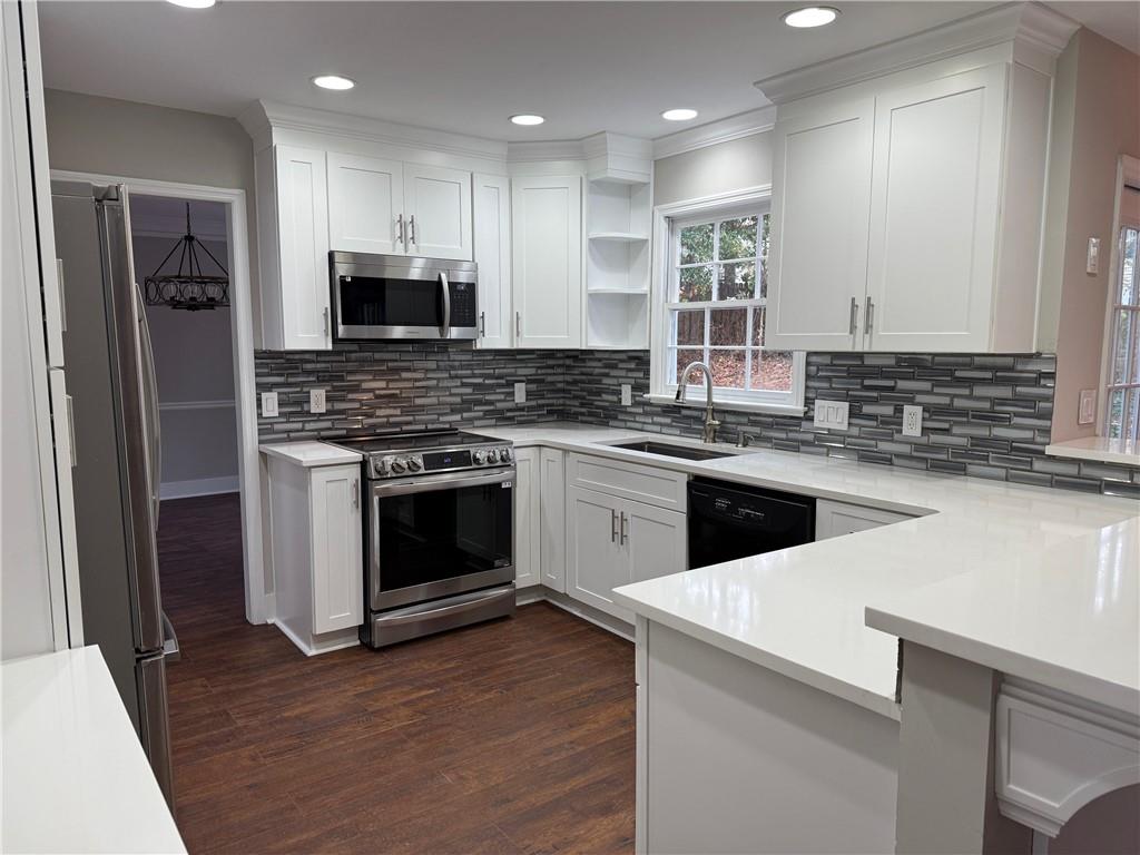 5325 Hillgate Crossing Alpharetta, GA 30005 - Photo 3 of 35 a kitchen with a stove top oven a sink and a refrigerator