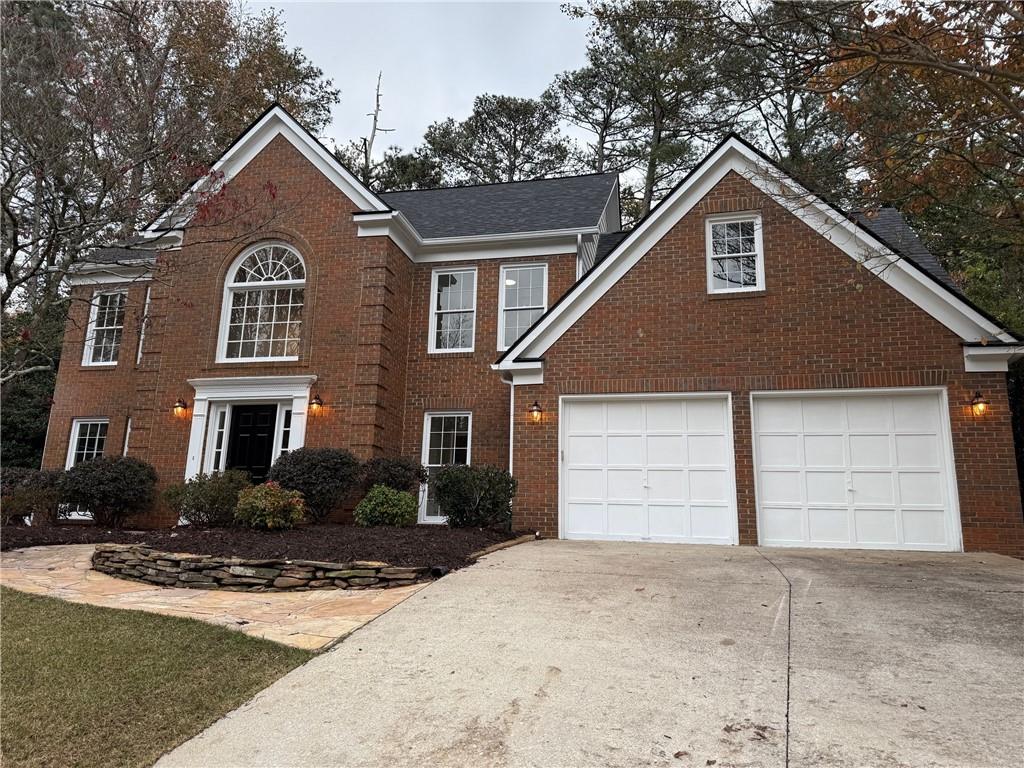 5325 Hillgate Crossing Alpharetta, GA 30005 - Photo 34 of 35 a front view of a house with a yard and garage