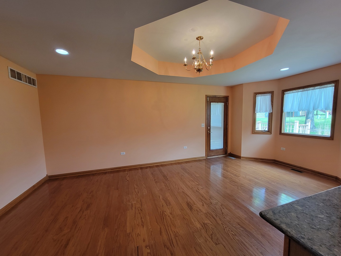 312 Kain Street Ottawa, IL 61350 - Photo 16 of 41 an empty room with wooden floor and chandelier
