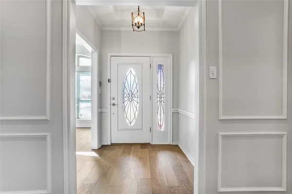 an empty room with wooden floor fireplace and windows