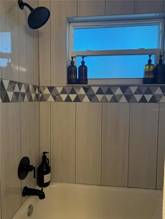 a bathroom with a granite countertop toilet sink and mirror
