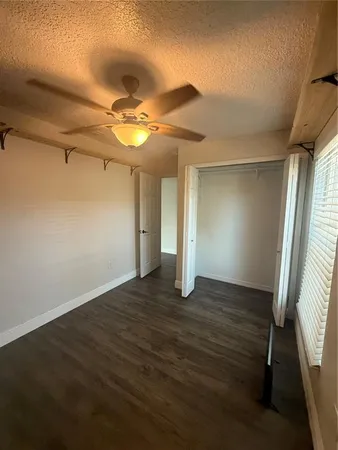 a view of hallway with wooden floor and stairs