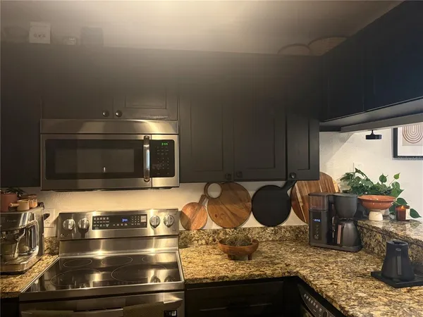 a kitchen with a stove and a microwave