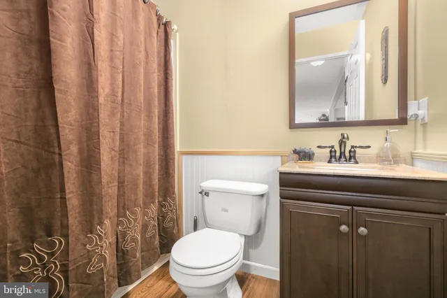 a bathroom with a toilet a sink and a mirror