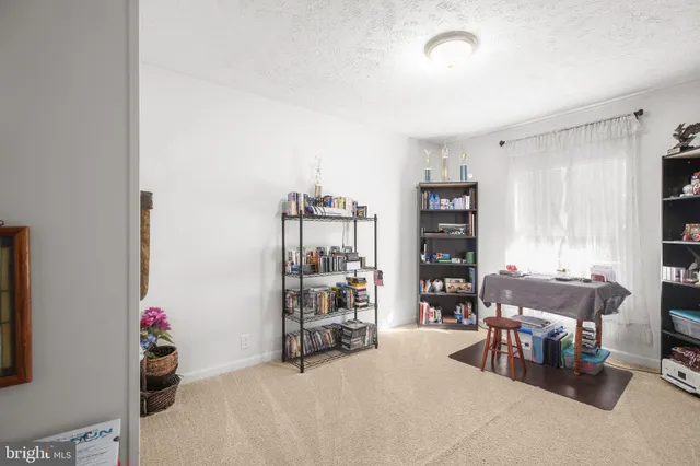 a living room with furniture and a book shelf