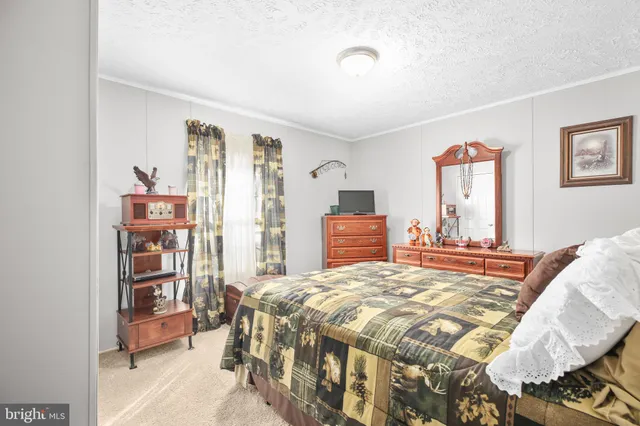 a bedroom with a bed a dresser and book shelf