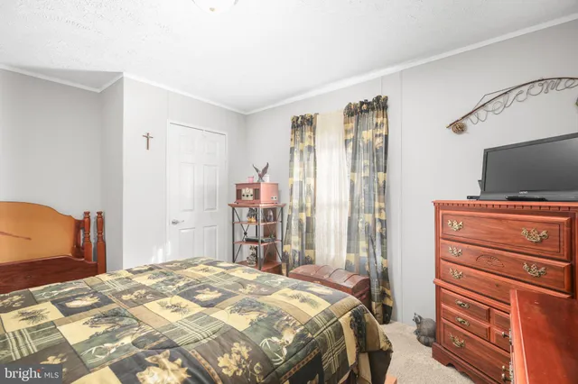 a bedroom with a bed and flat screen tv